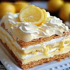 a close up of a piece of cake on a plate with lemons in the background