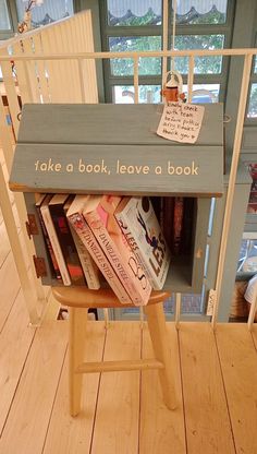 there is a book shelf with books in it on the floor next to a window