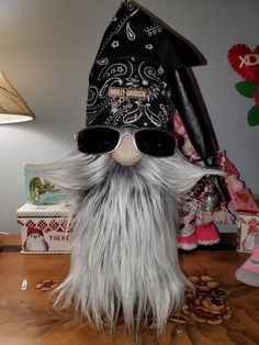 a gnome with sunglasses and a hat on top of a table