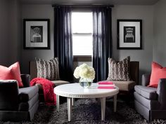 a living room filled with furniture and a white table in front of a large window