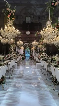 an elaborately decorated dining hall with chandeliers and tables set up for a formal function