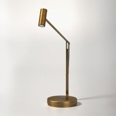 an image of a desk lamp that is on the table in the room with it's dim lighting