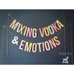 a sign that says mixing vodka and emotions on the side of a wall with flags hanging from it