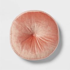 an orange round cushion on a white background