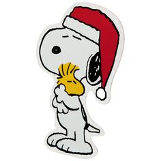 a snoopy christmas sticker with a santa hat on