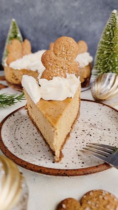 a slice of cheesecake on a plate with christmas decorations around it and silverware