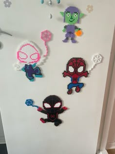 the door is decorated with different types of bead art on it, including spider - man and other cartoon characters