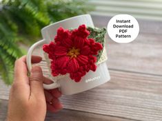 a hand holding a coffee cup with a crocheted flower on it and the words instant download pattern below