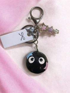 ✨ Handmade Inspired Soot Sprite Keyring  Bring the enchanting world of Studio Ghibli to life with this charming, handmade soot sprite keyring! Inspired by the magical soot sprites from your favorite Ghibli films, this keyring is lovingly crafted from polymer clay and features a durable, glossy finish thanks to a protective UV resin coating. ✨ Each soot sprite is adorned with a touch of sparkle and shimmering star accents 🌟 that capture the wonder and whimsy of the Ghibli universe. The design is Cute Keyrings, Soot Sprites, Resin Coating, Wedding Gift Baskets, All Things Cute, Uv Resin, Acrylic Beads, Studio Ghibli, Thoughtful Gifts