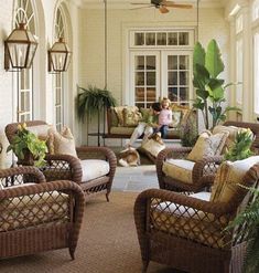 a living room filled with lots of wicker furniture