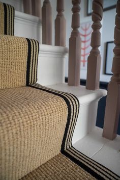 a close up view of some stairs with black and white striped carpet