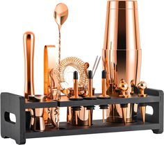 an assortment of copper colored items on a black shelf