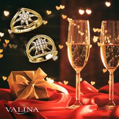 two champagne glasses with rings and a gift box