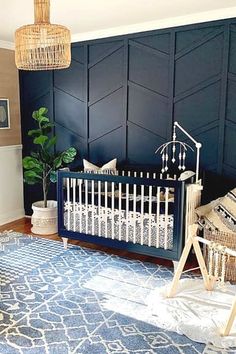 a baby's room with blue walls and white crib in the corner,