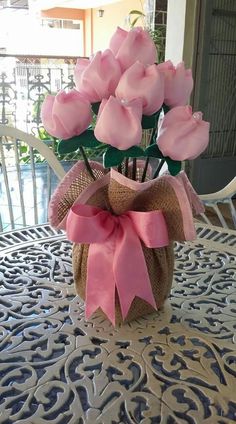 a vase filled with pink flowers on top of a table