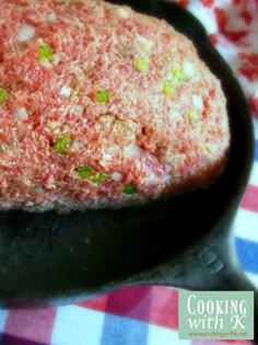 a close up of food in a pan on a checkered table cloth with the words cooking with k written below it