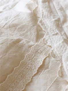 an image of white linen with lace on it