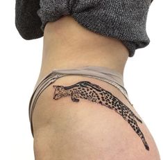 a woman with a tattoo on her stomach that has a cheetah on it