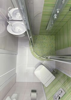 a small bathroom with green and white tile on the floor, sink, toilet and mirror