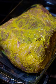 a large piece of meat covered in yellow stuff