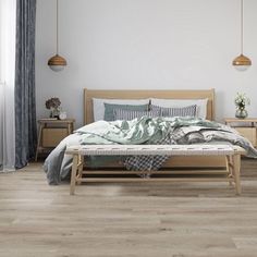 a bedroom with wood floors and white walls