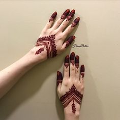 two hands with henna designs on them