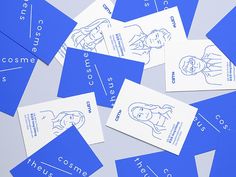 some blue business cards are laying on top of each other with the words cosme, cosme, cosme and cosme