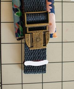 a close up of a belt on a tiled wall