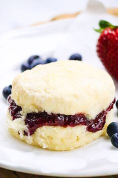 a biscuit with blueberries and strawberries on the side