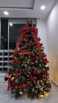 a decorated christmas tree with red bows and lights