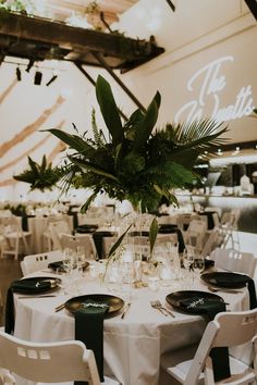 the tables are set with white linens and green centerpieces