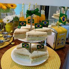 there are many sandwiches on the table with flags and drinks in front of them,