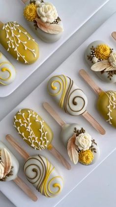 there are many different desserts on the tray together, including one with white frosting and yellow icing