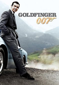 a man in a suit sitting on top of a blue car with the words goldfingerer