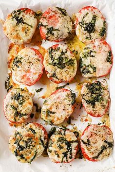 small stuffed tomatoes with cheese and herbs on top