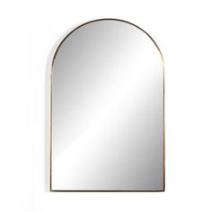 an arch shaped mirror hanging on the wall