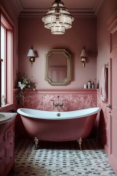 a bathroom with a pink bathtub and chandelier