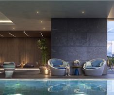 a living room with couches and chairs next to a swimming pool in front of a wall