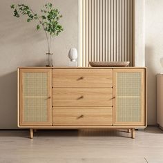 an empty room with a wooden cabinet and vases on the sideboard next to it