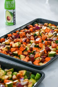 two trays filled with vegetables next to a can of avocado on the table