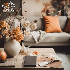 a living room filled with furniture and flowers on top of a coffee table in front of a couch