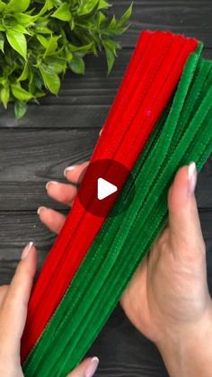 two hands are holding red and green napkins