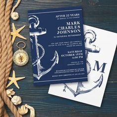 two wedding cards with an anchor, compass and starfish on the table next to them