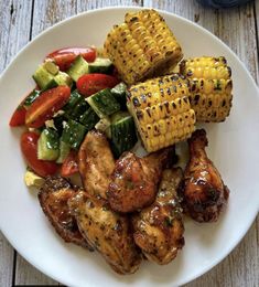 grilled chicken, corn on the cob, and veggies on a white plate