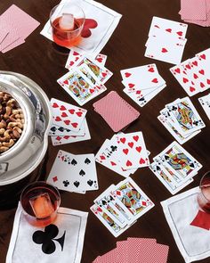 playing cards and wine glasses on a table