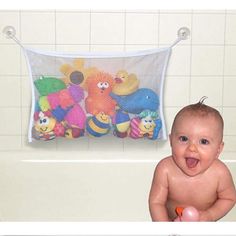 a baby sitting in a bathtub with stuffed animals hanging from the tub and on the wall