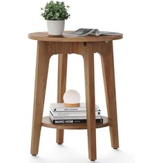 a small wooden table with books and a plant on the top, sitting next to it