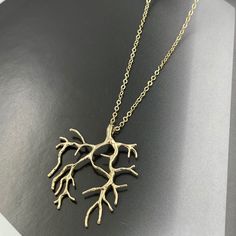 "❤️Deliver gifts on time with our recommended ship-by dates.❤️ - 16 DEC USPS first class mail - 18 DEC USPS Priority mail - 20 DEC USPS Priority mail express Channeling the mystique of the ocean's depths, the Gold Coral Branch Charm Necklace features a finely crafted gold pendant, reminiscent of intricate coral branches. This necklace offers a blend of natural inspiration and gleaming opulence, perfect for those looking to adorn themselves with a piece that echoes the wonders of the sea in luxurious gold. Measurements: Necklace length is 16\" plus 2 inches extender chain for adjustment. Branch is 30 mm x 38 mm This necklace would be a PERFECT GIFT for you and your family and friends! Comes beautifully packaged in a gift box!  Click here to see more Modern Necklaces: https://www.etsy.com/sh Gold Nature-inspired Metal Necklace, Gold Nature-inspired Necklace With Large Pendant, Gold Nature-inspired Pendant Necklace, Nature-inspired Gold Pendant Necklace, Green Wedding Jewelry, Green Statement Earrings, Forest Jewelry, Natural Inspiration, M Necklace