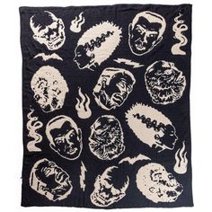 a black and white cloth with skulls on it, including the faces of people in different colors