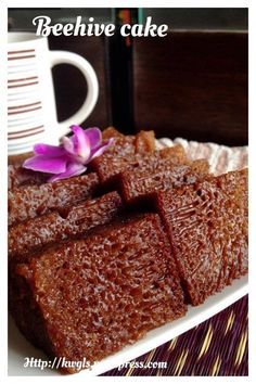 some brownies are on a plate with a purple flower